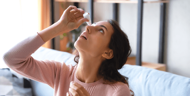 woman using eye drops