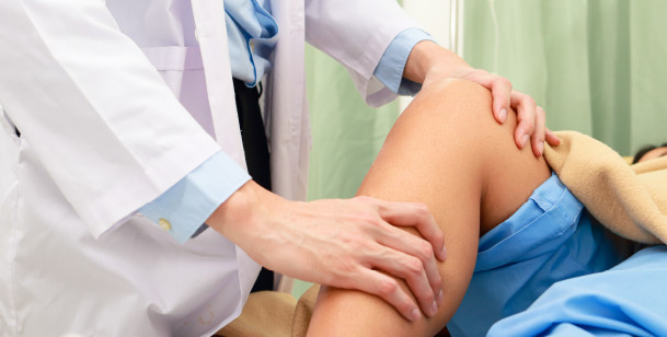 Doctor examining a patient's knee