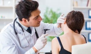 Doctor treats his patients ear allergy