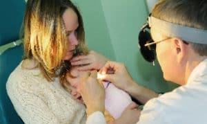 Doctor treats baby's ear infection
