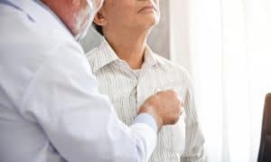 A doctor listening to a patient's lungs in a Houston, TX emergency room