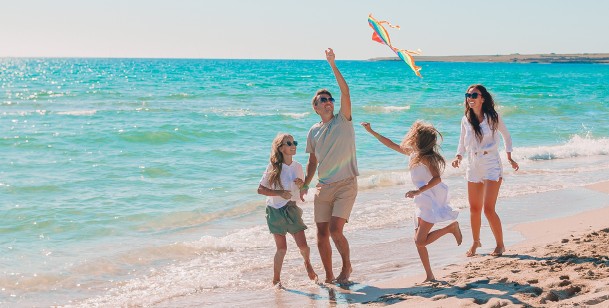 family playing on the beach 