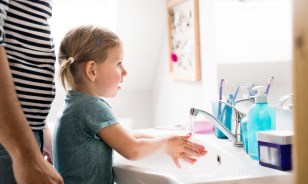 A girl washing hands to avoid catching the flu in Houston, TX