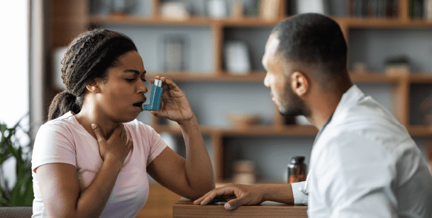 woman using asthma inhaler 
